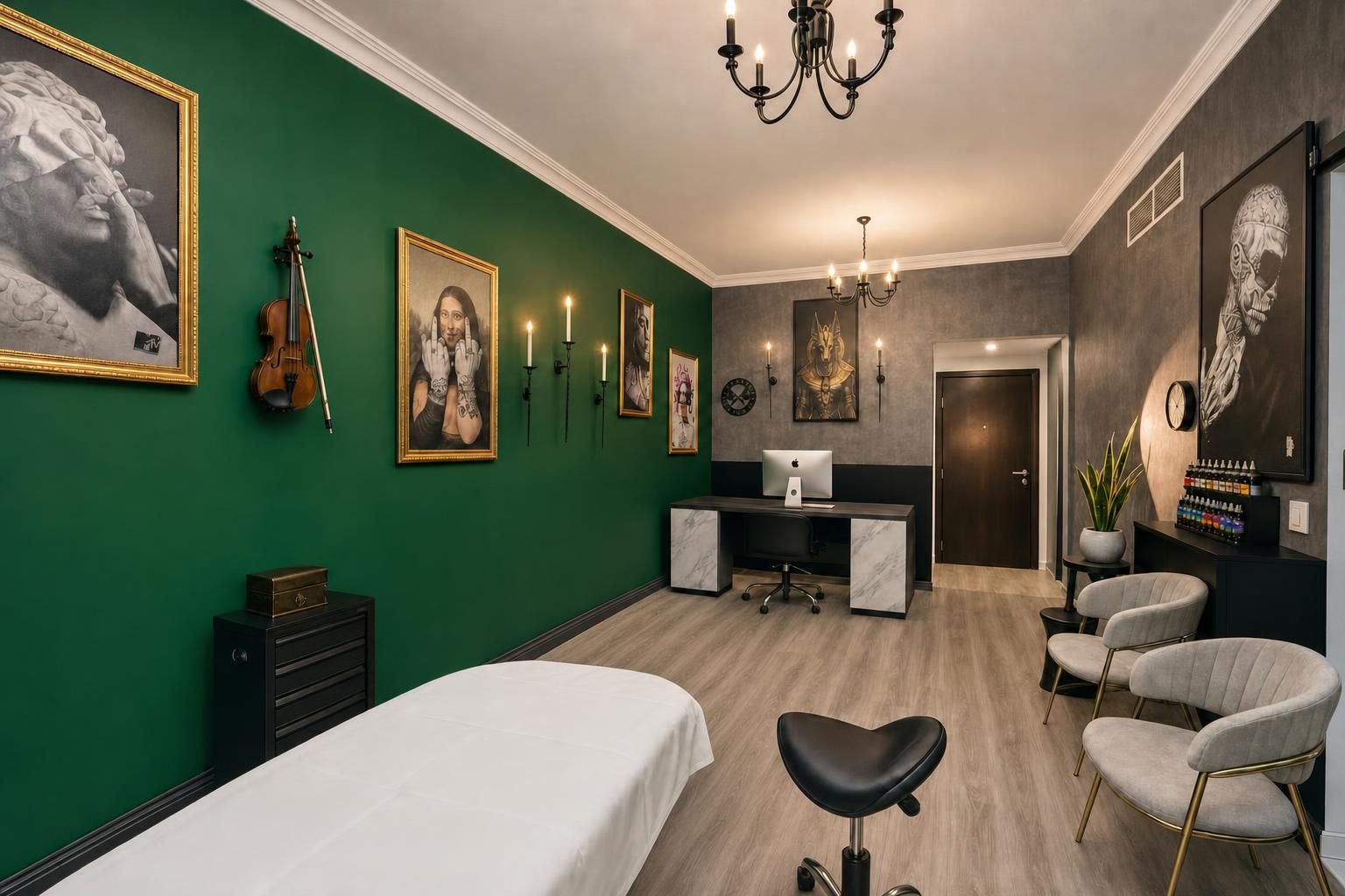 The studio: emerald wall with gold frames, tattoo bed, marble desk
